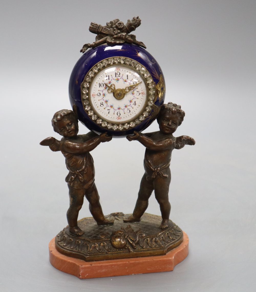 A French porcelain and bronze putti mantel clock, with diamonte decoration to the dial, height 20cm